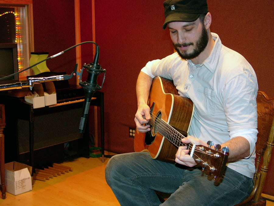 An SF-24 stereo ribbon mic positioned in front of an acoustic guitar