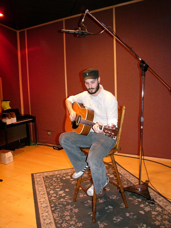 An SF-24 stereo ribbon mic placed horizontally several feet above an acoustic guitarist
