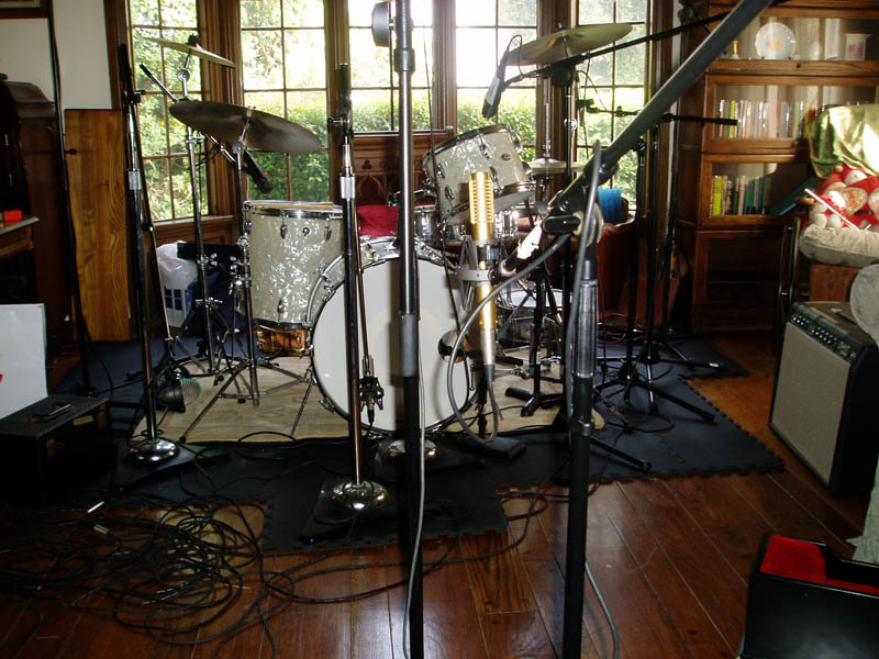 A single R-122 ribbon mic placed waist high in front of a drum kit in a home studio